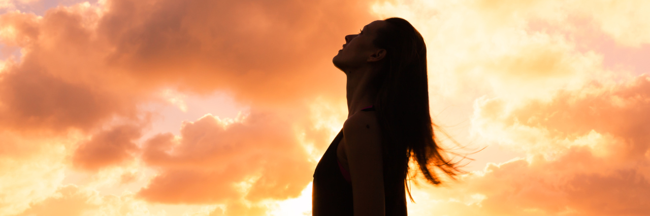 Chiari Malformation: Holding Out Hope on Long Chronic Illness Journeys woman looking up at a sunset