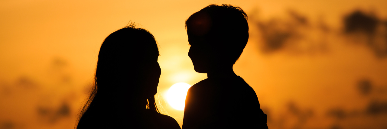 happy loving mother and little son at sunset