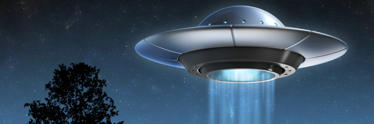 Autism Feels Like Being Born on the Wrong Planet Alien spaceship hovering over land.