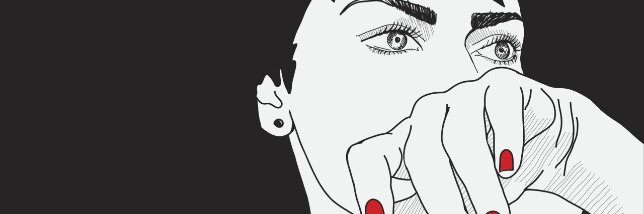 The Words From My Therapist That Kept Me Fighting Anorexia woman with dark hard puts her hand up to her face