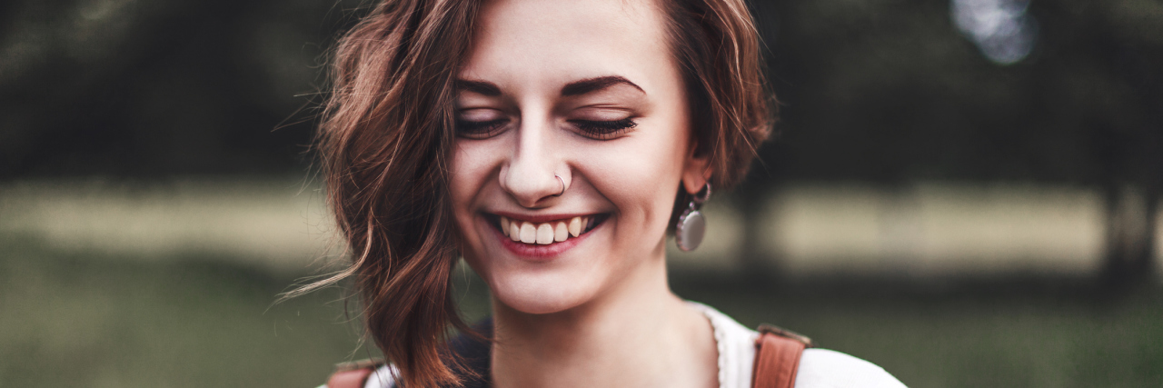 Finding Humor in Bad Medical Experiences woman walking outside and laughing