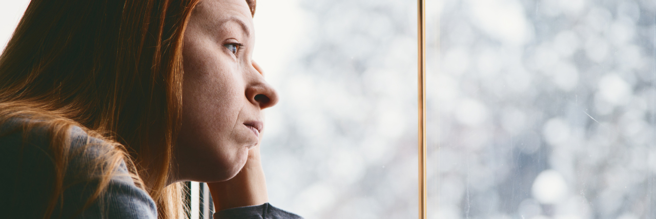 Chronic Illness: You Shouldn't Ask People Why They Don't Have Children woman leaning on her hand and looking out the window