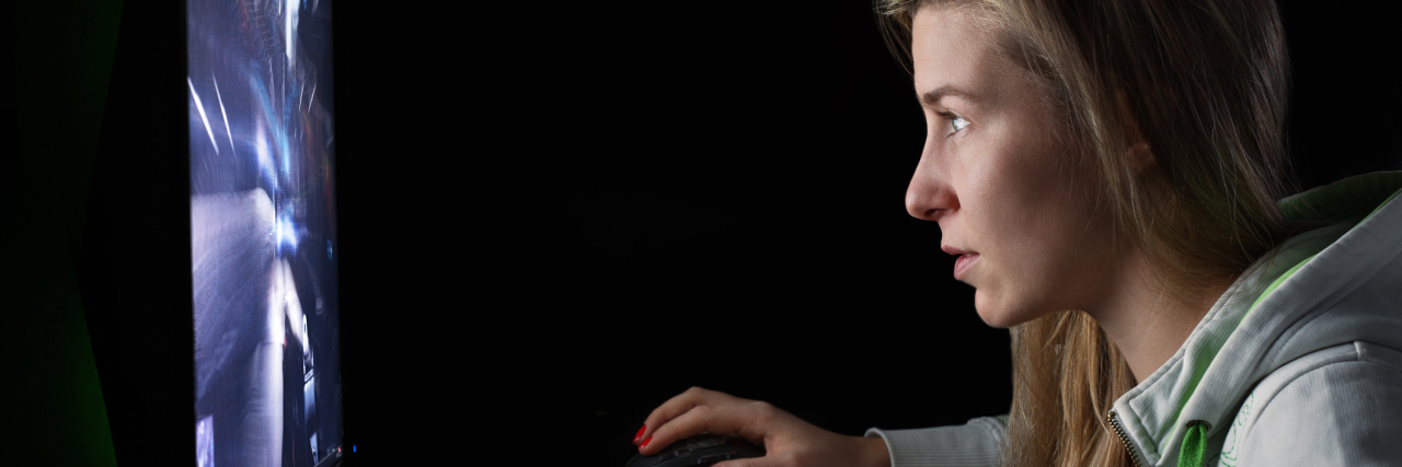My Fears About Playing Video Games With Fibromyalgia woman playing video games on her computer