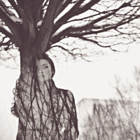 double exposure of woman and tree branches