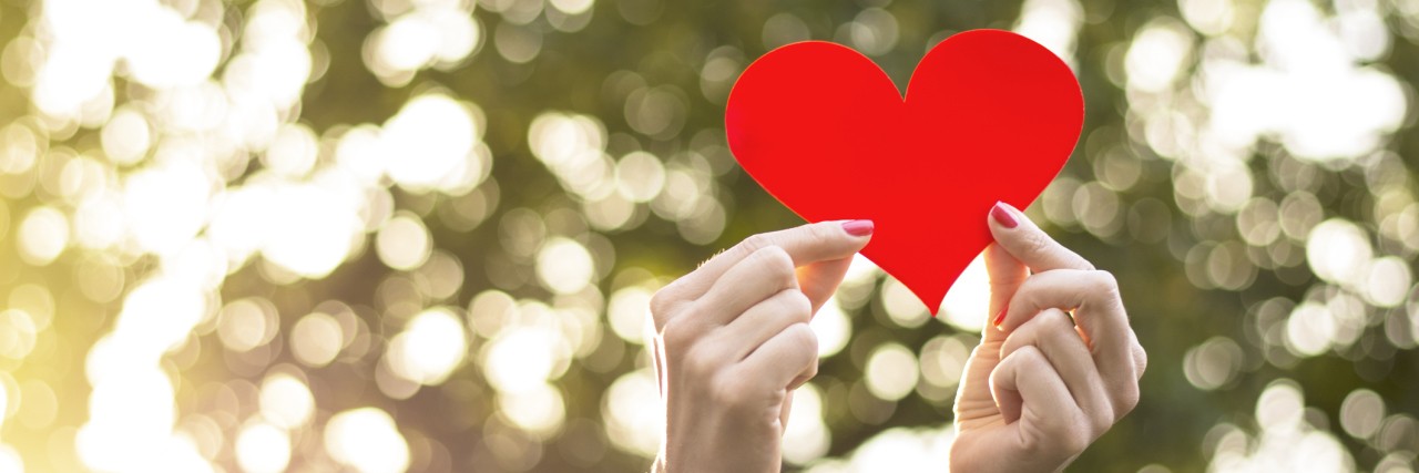 Lupus: Focusing on Love and Happiness in Life With Chronic Illness Woman holding red heart in her hands