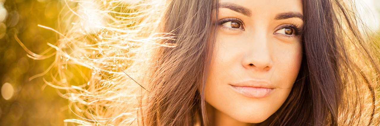 How to Hold On to Your Identity With Chronic Illness woman standing outside in autumn