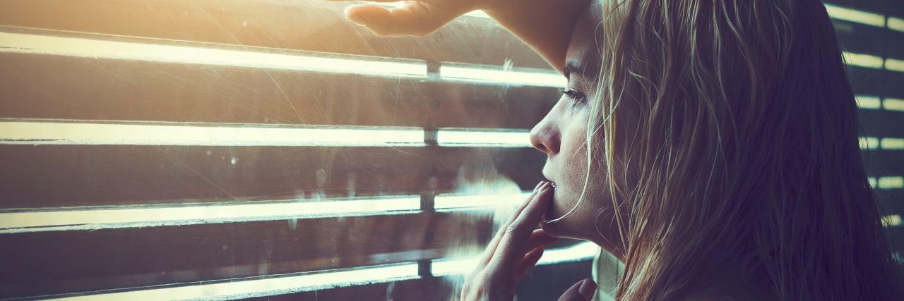 What to Reminder Yourself If You're a Mother With Depression A woman looking out a window