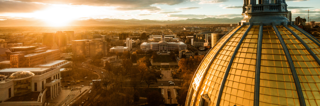 beautiful drone image of the golden cupola of the Colorado state capital building in the city of Denver
