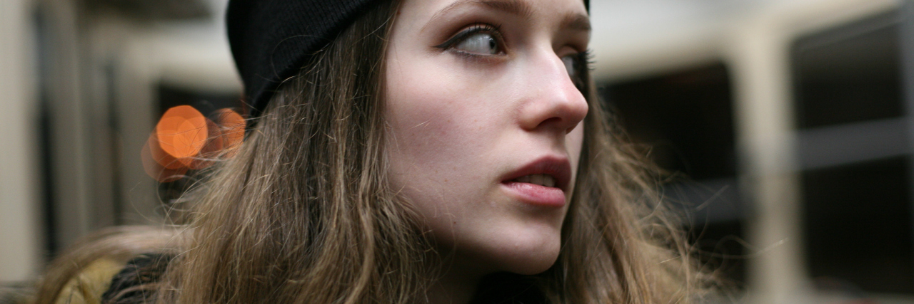 How to Fight Back Against Anxiety Thoughts young woman on public transport looking anxious