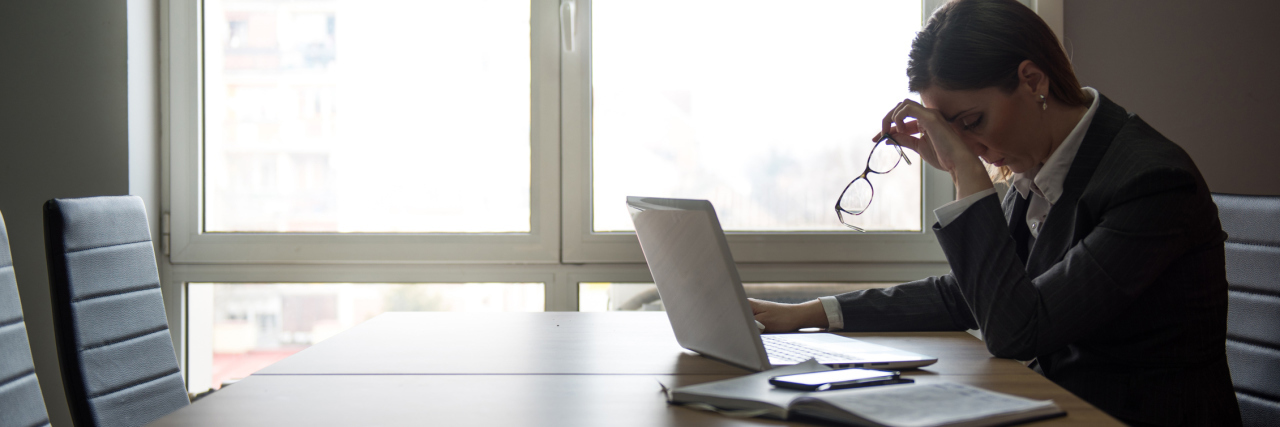 CIDP: Deciding When to Quit Working Due to Chronic Illness woman sitting in an office looking upset