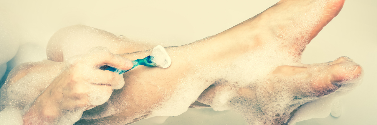 What Shaving My Legs Means for My Mental Health Woman shaving her legs