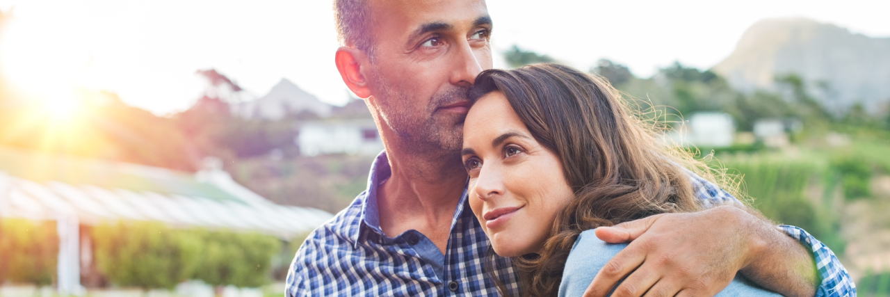 ME/CFS: What It Looks Like to Love Someone With Chronic Illness man and woman hugging and sitting outside