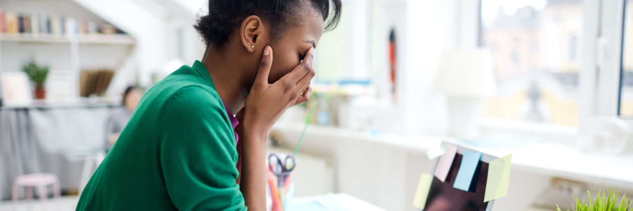 woman feeling stressed while working at home