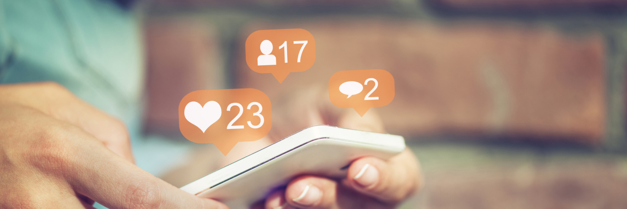 Endometriosis: How Social Media Can Be Hurtful on Bad Health Days woman checking social media on her phone