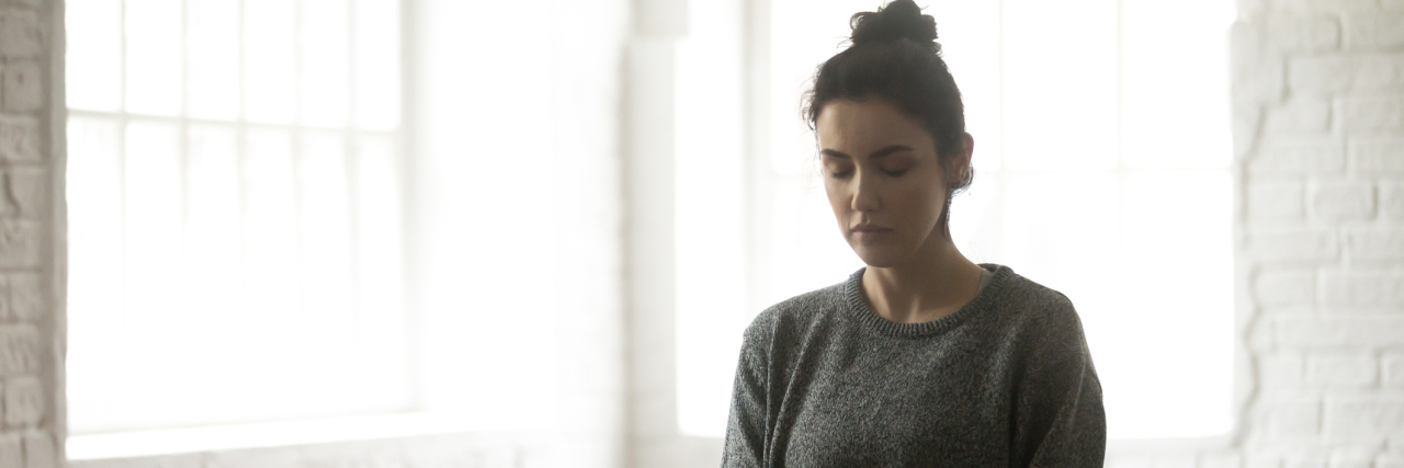 How Meditation Helps Me Deal With Stress, Anxiety and Fibromyalgia woman sitting on the floor meditating