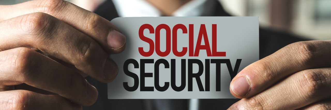 How SSI Can Help People With Disabilities Become Employed Man holding up Social Security sign.