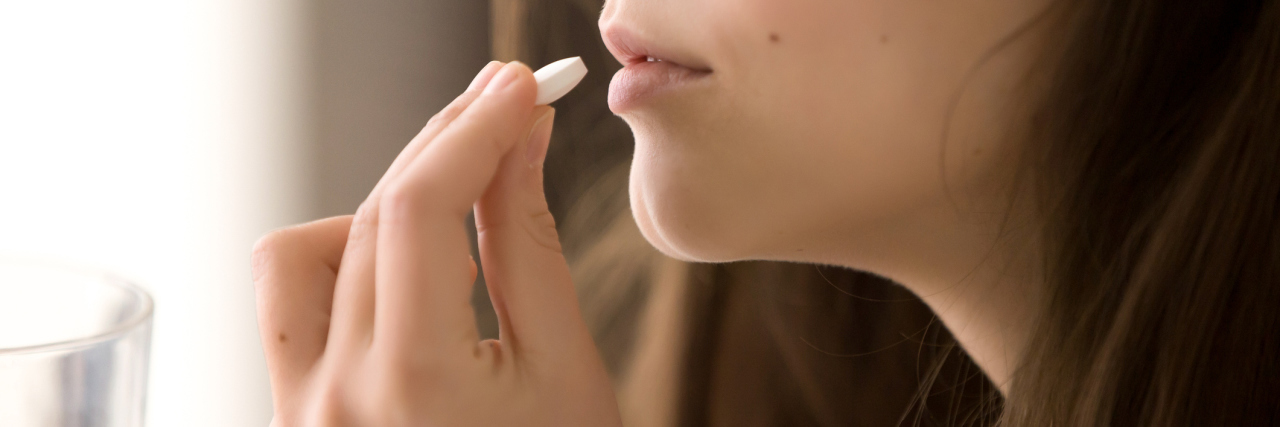 Medication Is Not a Cure for Chronic Illness woman taking medication