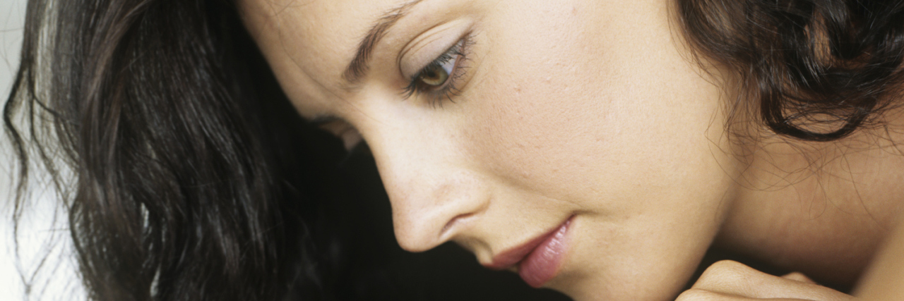 Lupus: Why You Shouldn't Tell a Sick Family Member to 'Slow Down' woman leaning on her arms looking down