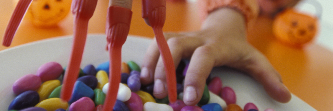 10 Tips for Getting Through Halloween With an Eating Disorder children reaching for halloween candy