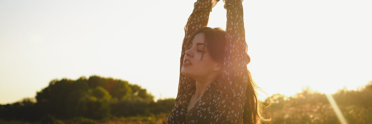 Young beautiful woman enjoying day in nature