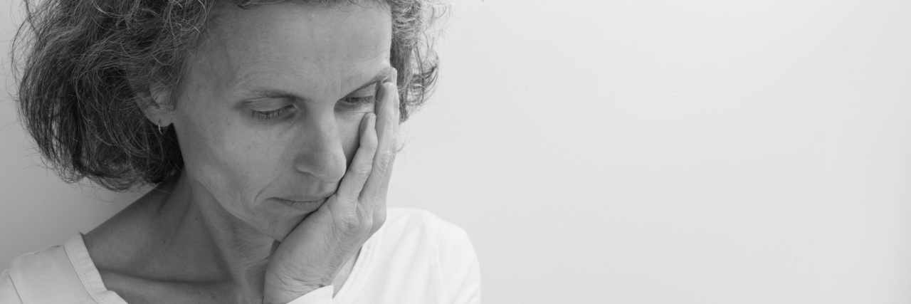 Menopause and DID: What It's Like for Me and My Alters middle aged woman black and white photo looking upset