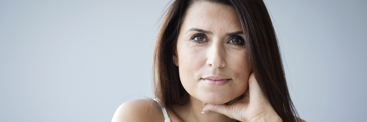 How I Stay Involved in My Community After Medically Retiring A middle-aged woman looking into the camera with a determined look.