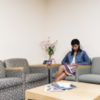 woman sitting in the waiting room of a doctor's office