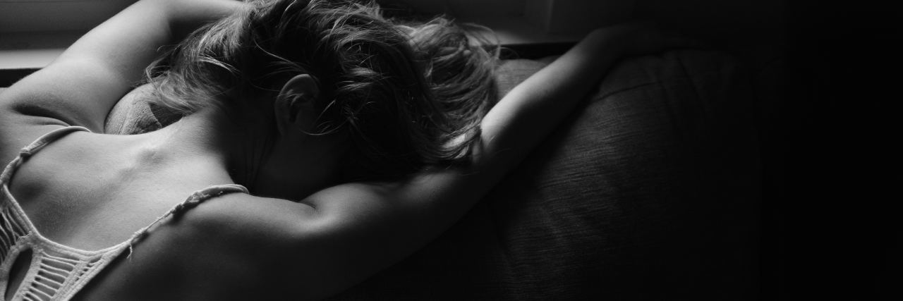 How I'm Finding Meaning in the Meaningless of My Mental Illness woman laying on couch