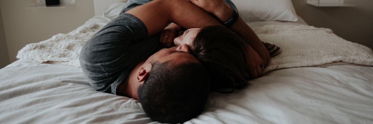 What Happened When I Decided Not to Hide My Anxiety couple lying on bed holding each other