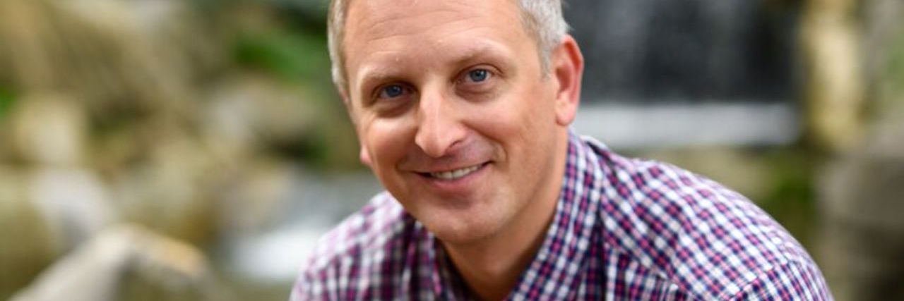 10 Things I Realized as a Man Who Struggled With (and Beat) Depression man sitting on a rock looking happy