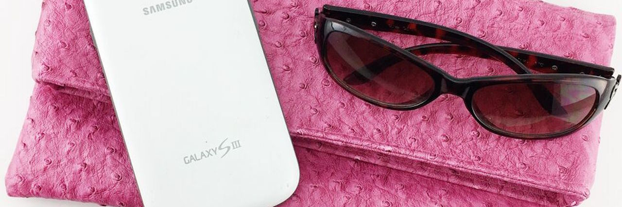 colorful bag with sunglasses and phone