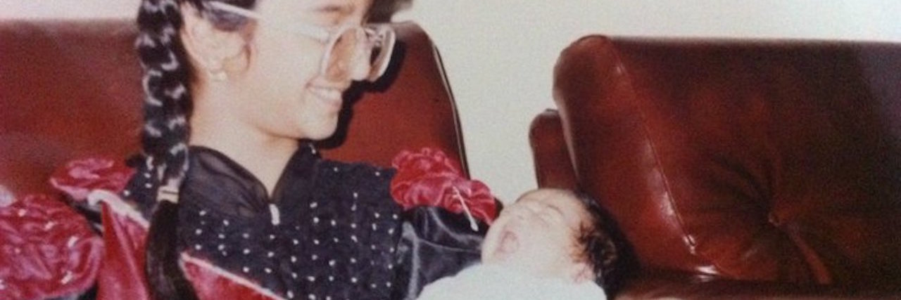 Thank You to My Older Sister for Supporting Me Through Chronic Illness girl holding her baby sister