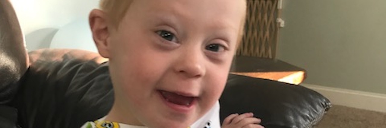 To Elmo, My Son With Down Syndrome's First Friend Little boy wearing "sesame Street" pajamas