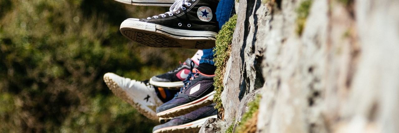 4 Simple Ways You Can Be an Ally to the Mental Health Community peoples feet dangling as the sit on a wall