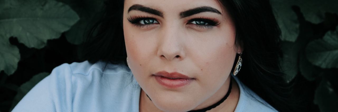 How Avoiding My Fears and Triggers Actually Worsened My OCD woman with dark hair looks directly at the camera