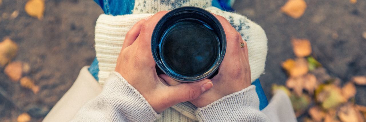 Self-Care Tricks I Practice for Bipolar Disorder woman holding coffee cup outside in autumn