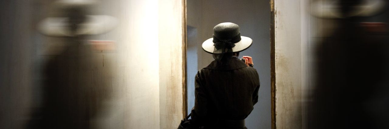 Why Suicide Prevention Day Bothers Me A woman in a dark hat double exposed image