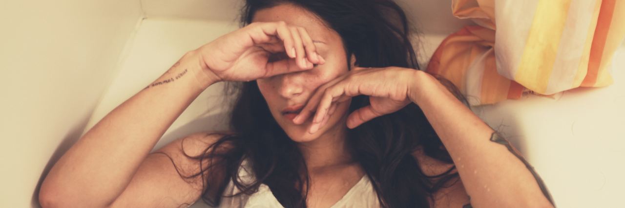 When You're Battling Both Mental and Chronic Illness girl sitting in tub covering face