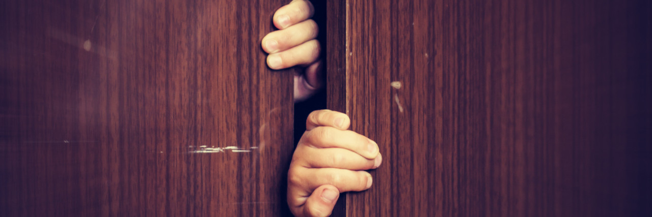 Coming Out as a Person With an Invisible Disability Hands pulling open closet doors.