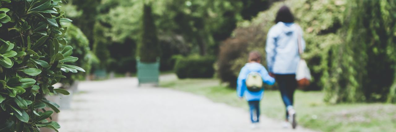 I Am a Mother With a History of Self-Harm A mom and daughter walk hand in hand down a street