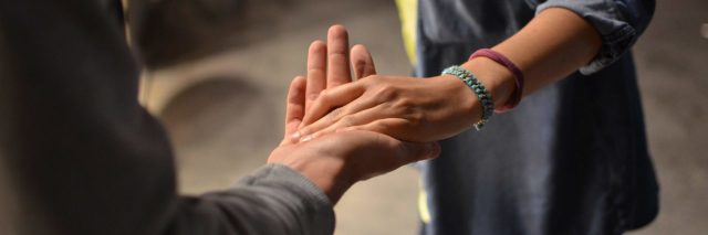 two people holding hands help gesture