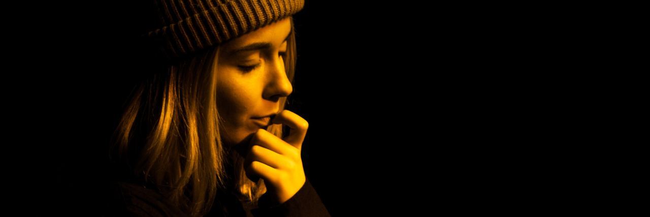 This Is What It Feels Like to Have a Panic Attack upset worried woman in darkness