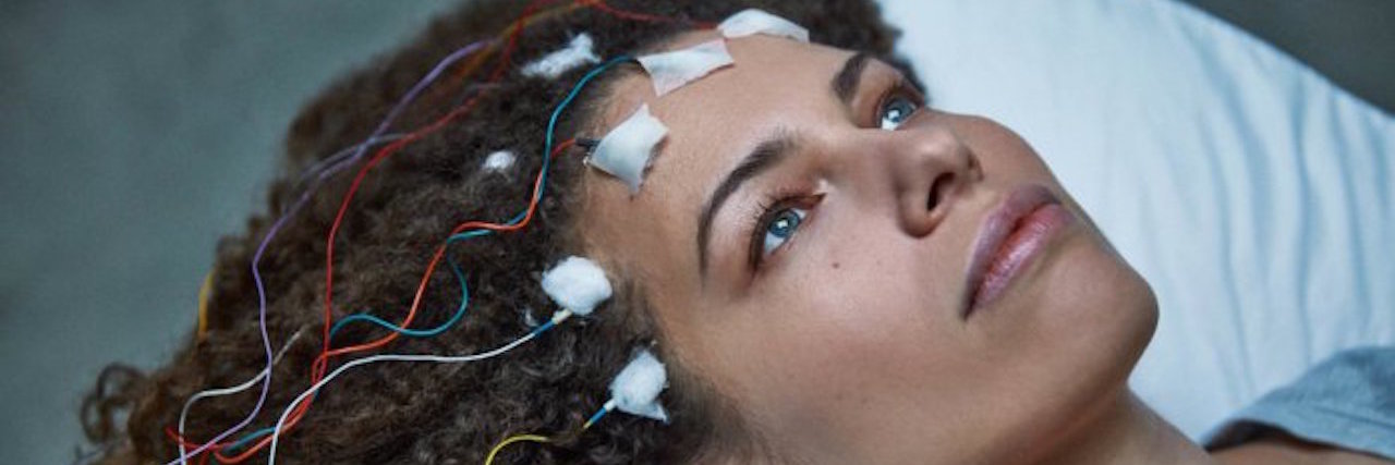 Attending a Screening of Jennifer Brea's Film 'Unrest' About ME/CFS woman with electrodes on her head from the film 'unrest'