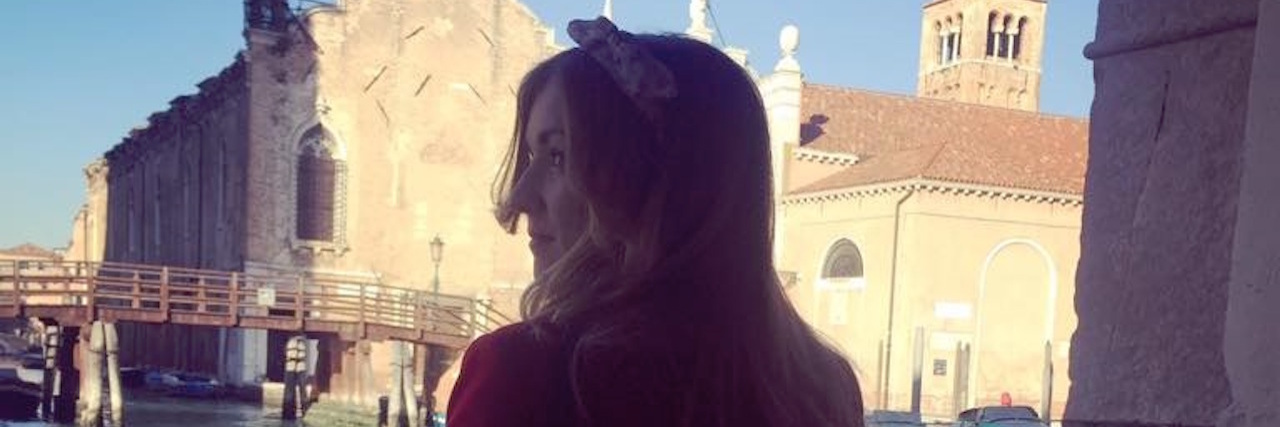 Traveling Tips When You Have Hypothyroidism woman standing near a canal in venice