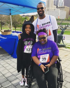man, woman and a young girl wearing epilepsy awareness shirts
