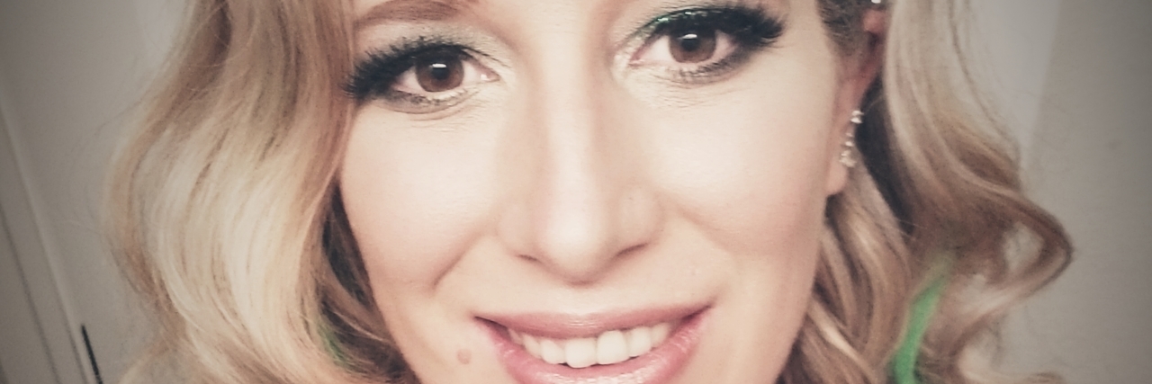 Are We Conditioned to Not Take Concussions Seriously? Nikki Stang, woman with shoulder-length blonde hair, wearing a black tank top.