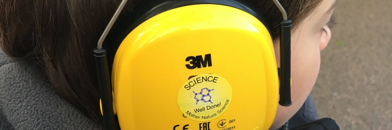 The Story Behind the Photo of My Autistic Son Wearing Ear Defenders autistic boy with headphones on