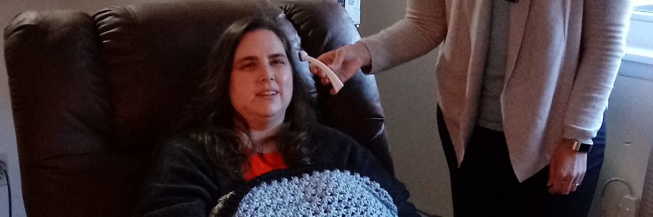 What It's Like to Be a Rare Disease Adult With Stiff-Person Syndrome woman receiving an infusion while her nurse stands by her side