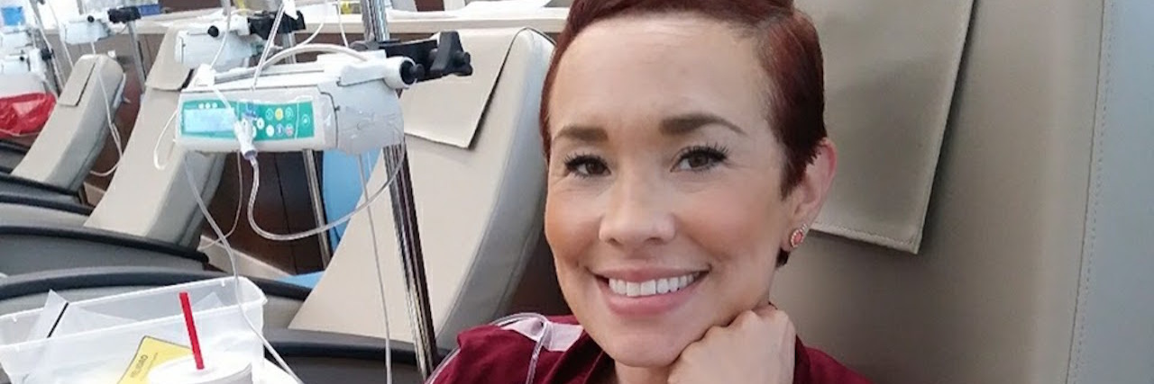 Why I Won't Be Receiving a Chemo Graduation Certificate for My Lupus A photo of the writer sitting in a chemo chair.