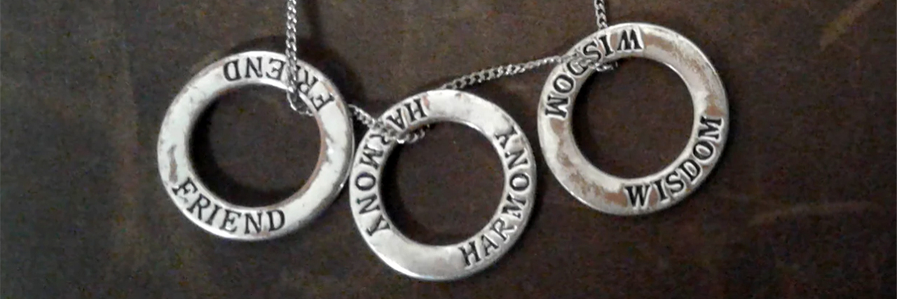 What I've Learned Since Leaving Residential Eating Disorder Treatment necklace with three rings saying friend harmony wisdom